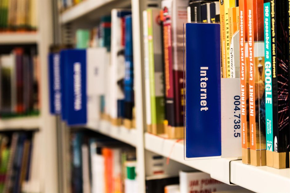 A collection of vintage books displayed elegantly on a reflective surface, ideal for education and literature themes.